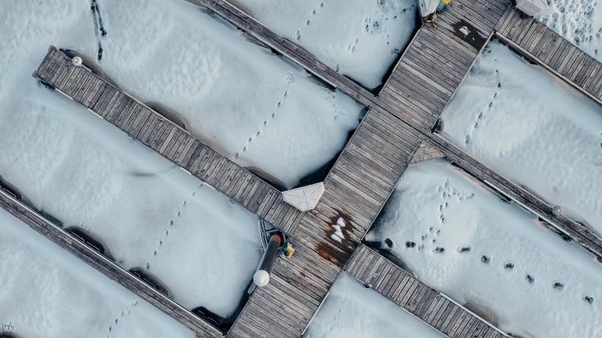 Aerial photograph of a snow-covered wooden dock with footprints in Pepin, Wisconsin.