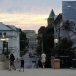Capturing the vibrant city atmosphere with people walking and urban murals in Wroclaw.