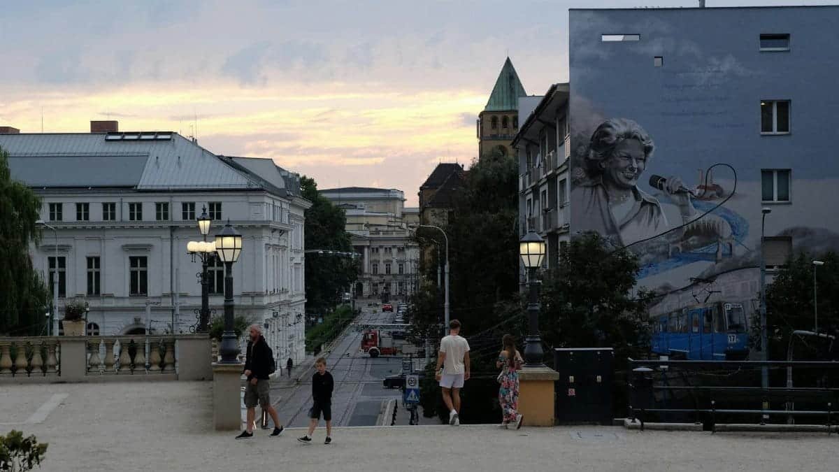 Capturing the vibrant city atmosphere with people walking and urban murals in Wroclaw.