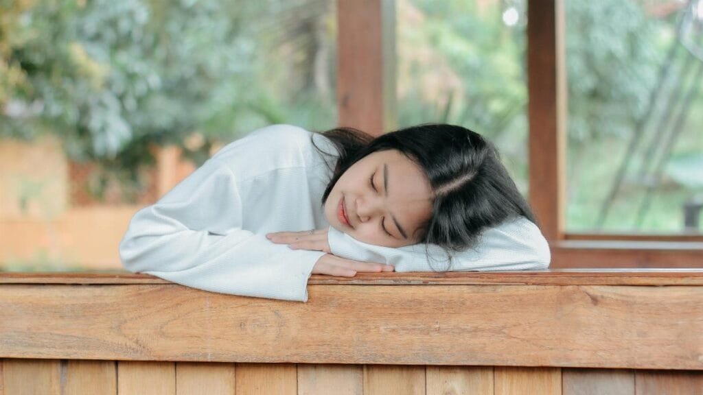 Serene moment as a woman enjoys a peaceful rest outdoors. Relaxation and tranquility captured naturally.