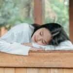 Serene moment as a woman enjoys a peaceful rest outdoors. Relaxation and tranquility captured naturally.