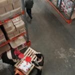 High angle view of warehouse workers handling inventory and logistics operations.