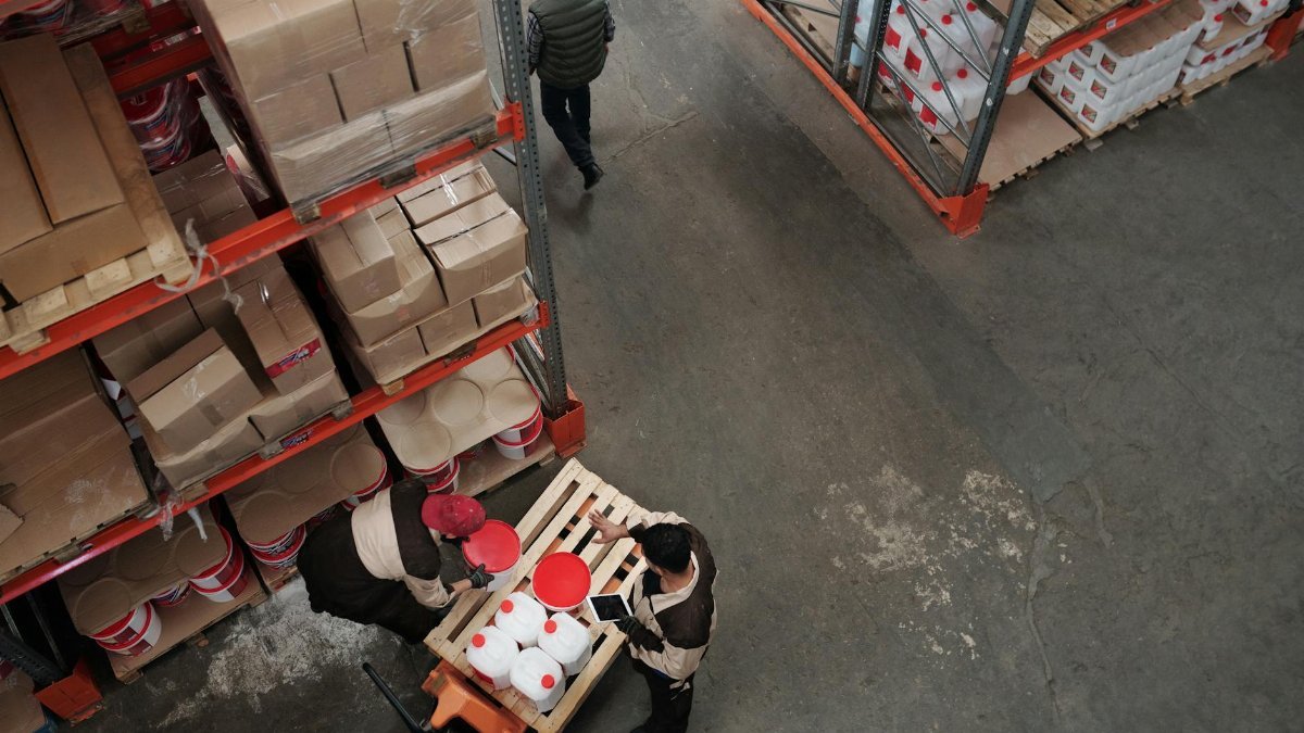 High angle view of warehouse workers handling inventory and logistics operations.