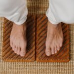 Close-up of feet on an acupressure board for holistic wellness practice.
