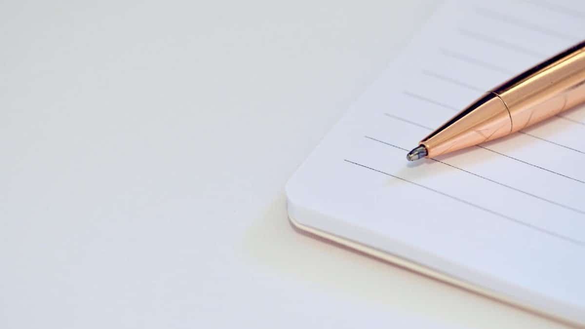 A sleek pen placed on a notebook, symbolizing productivity and planning.
