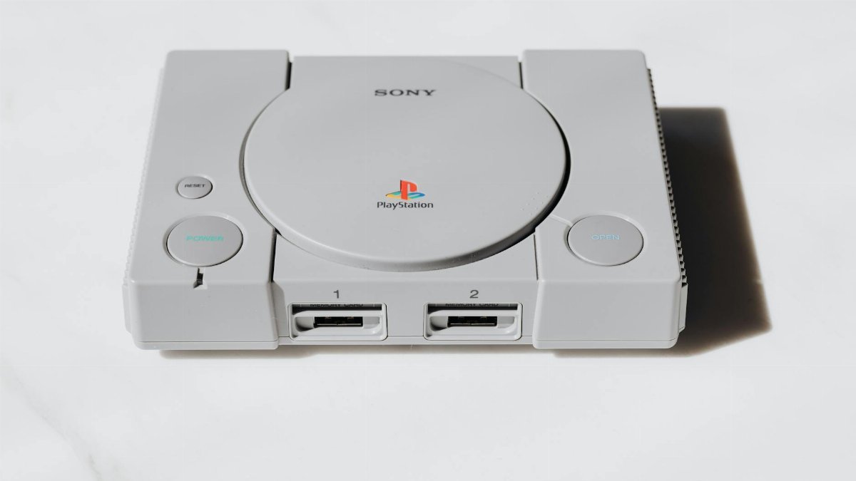 A classic Sony PlayStation console captured on a white background exuding retro gaming nostalgia.