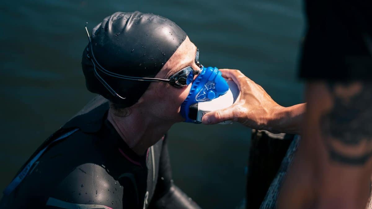 A swimmer uses a rescue mask for oxygen after completing an outdoor swim.