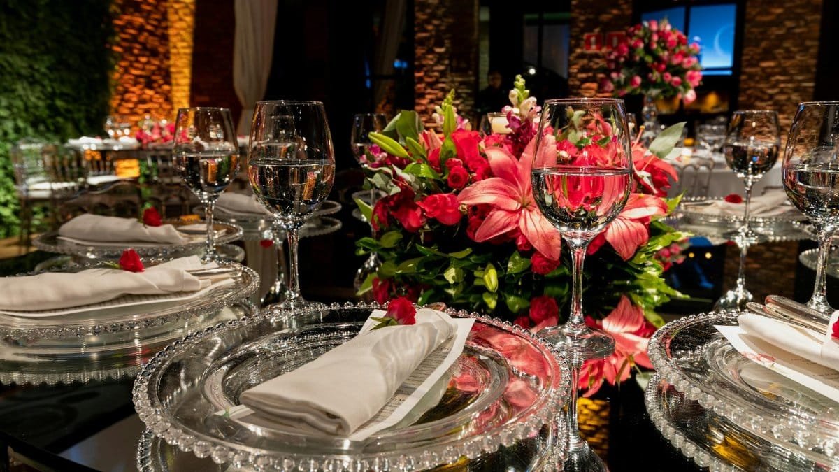 A beautifully arranged wedding table with crystal glassware and vibrant floral centerpiece, perfect for an elegant occasion.
