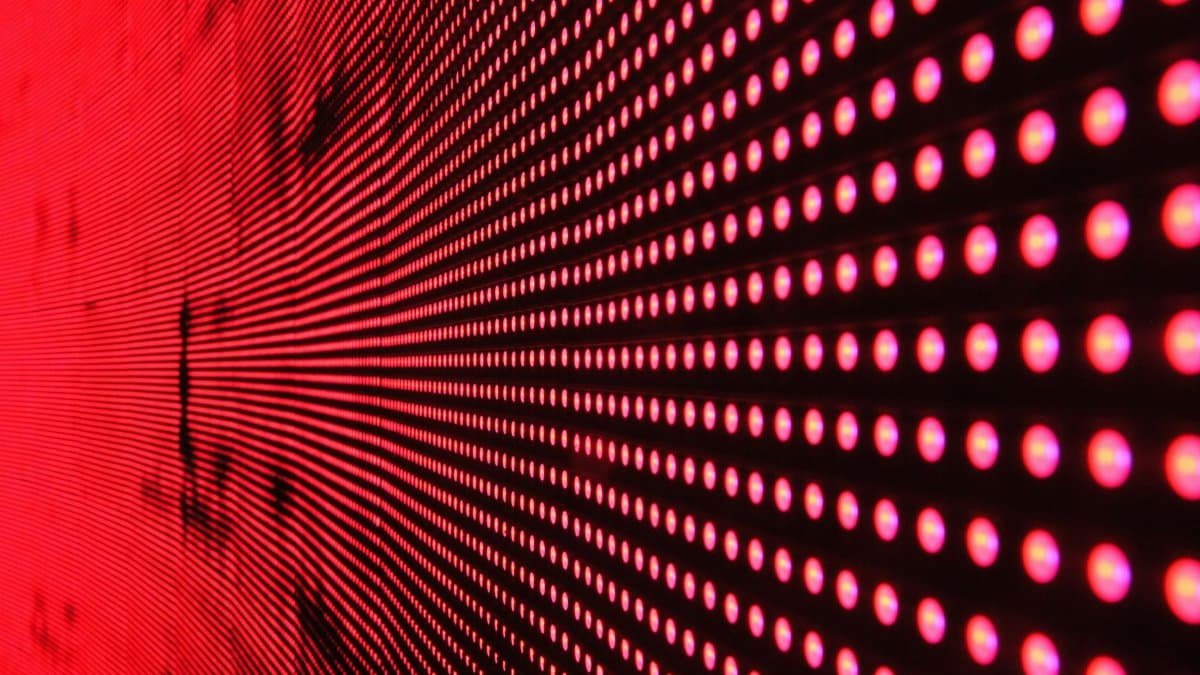 Vibrant abstract pattern of illuminated red LED lights forming a dynamic design.