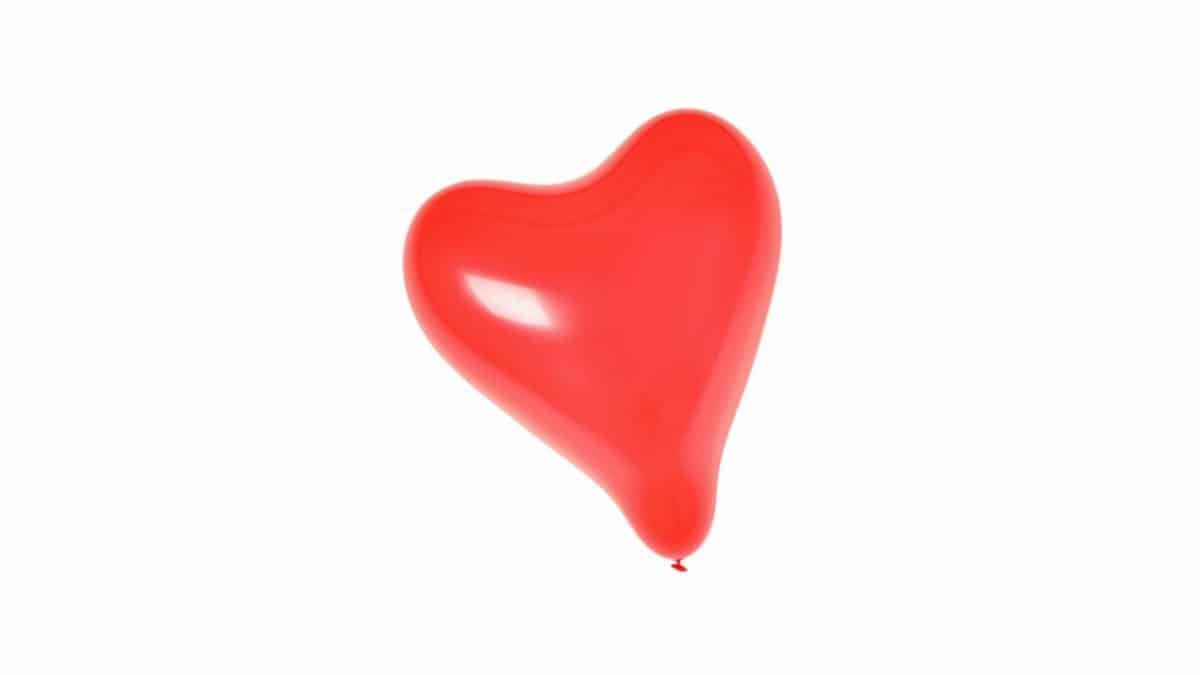 Bright red heart-shaped balloon isolated on white. Perfect for love-themed designs.