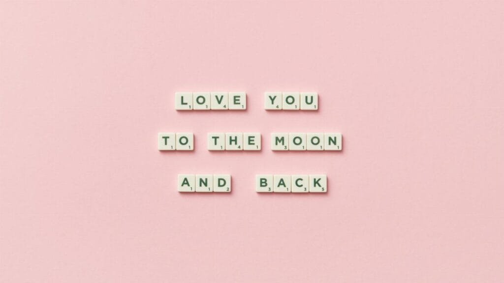 Letter tiles spelling 'Love You to the Moon and Back' on a pink background.