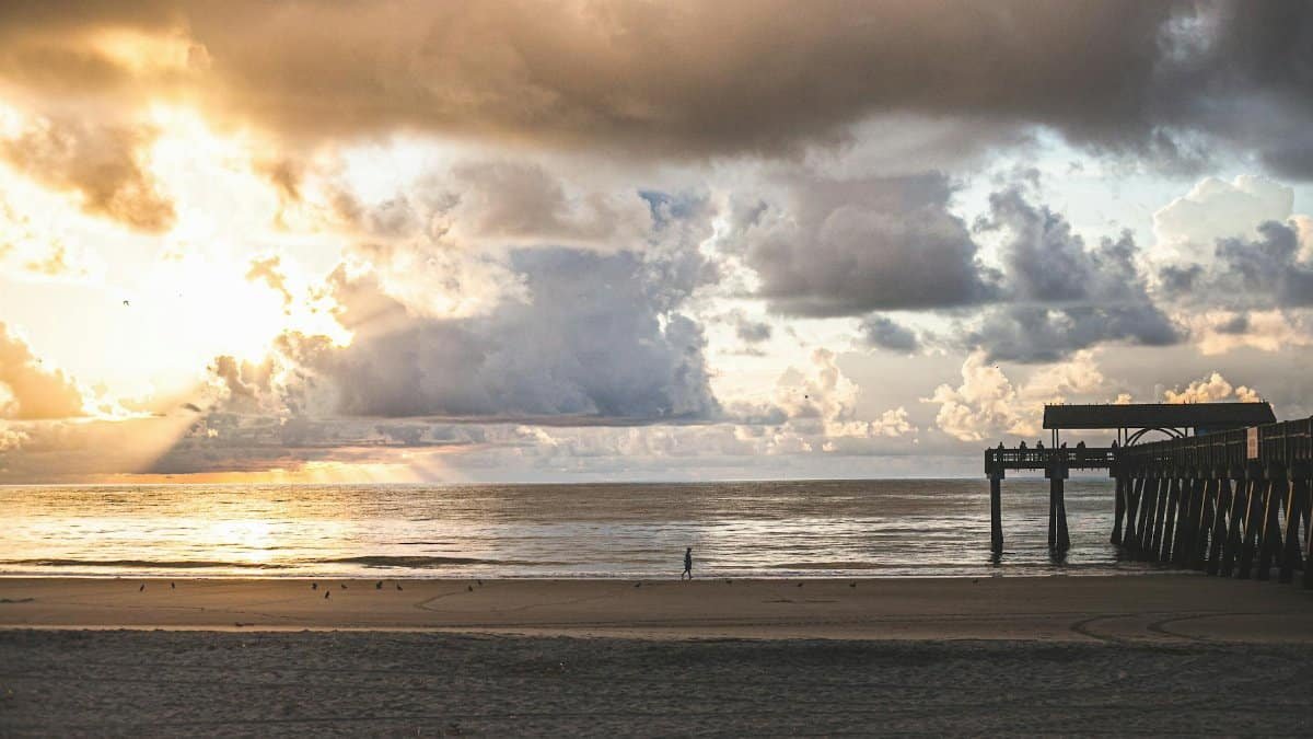 A stunning sunset with dramatic clouds over Tybee Island Pier, Savannah, Georgia.