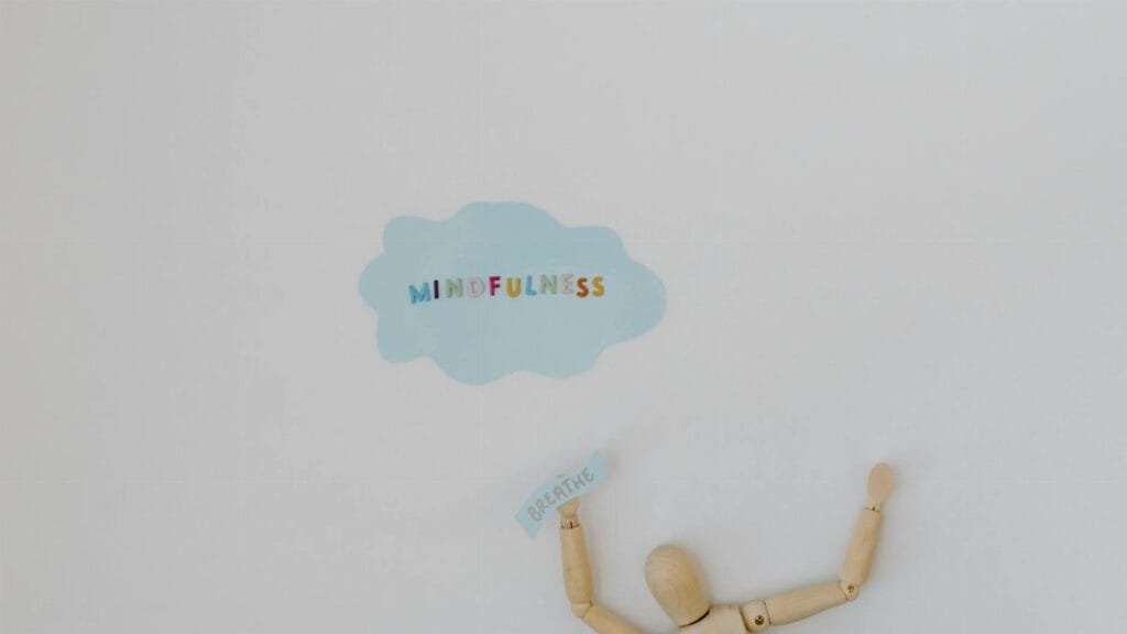 Wooden figure promoting mindfulness and breathing on a clean white background.