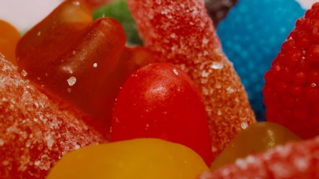 Vibrant assortment of sugary gummy candies up close, showcasing textures and colors.