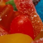 Vibrant assortment of sugary gummy candies up close, showcasing textures and colors.