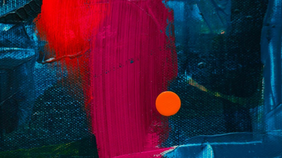 Dynamic close-up of a colorful abstract acrylic painting featuring bold textures.