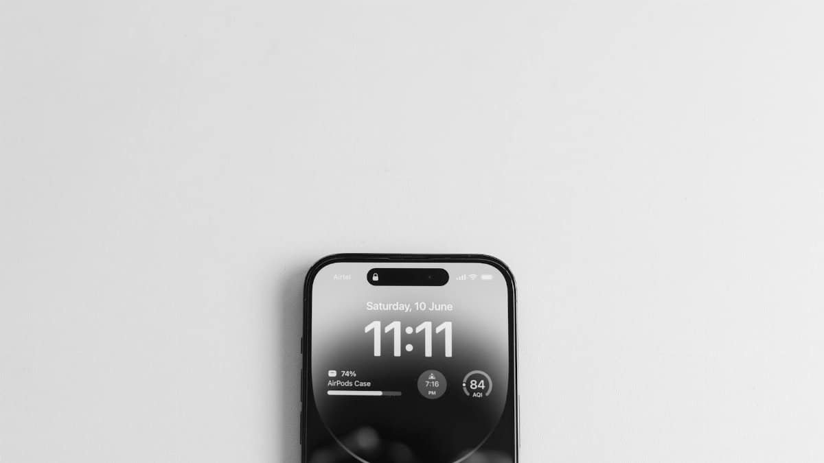 Top view of a smartphone displaying the time 11:11, on a minimalist white background.