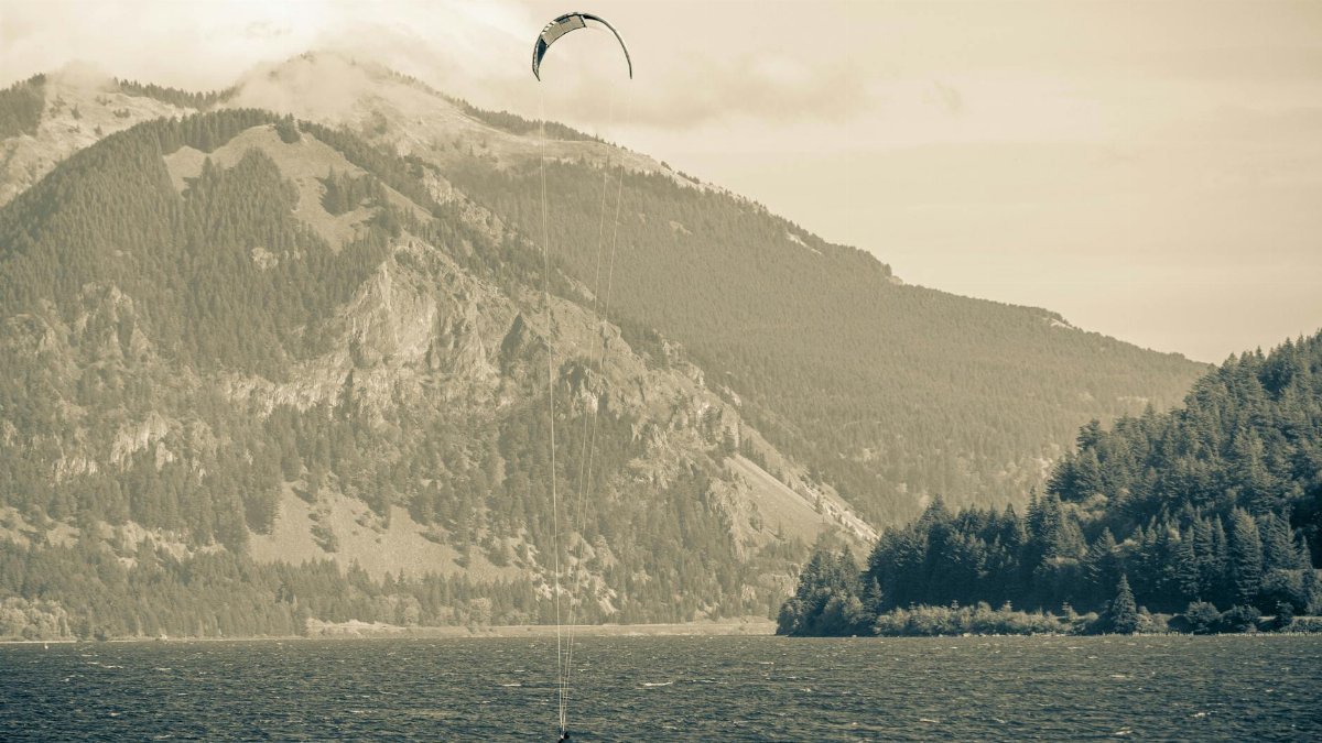 Kitesurfer on the Columbia River with majestic mountains in Stevenson, Washington.