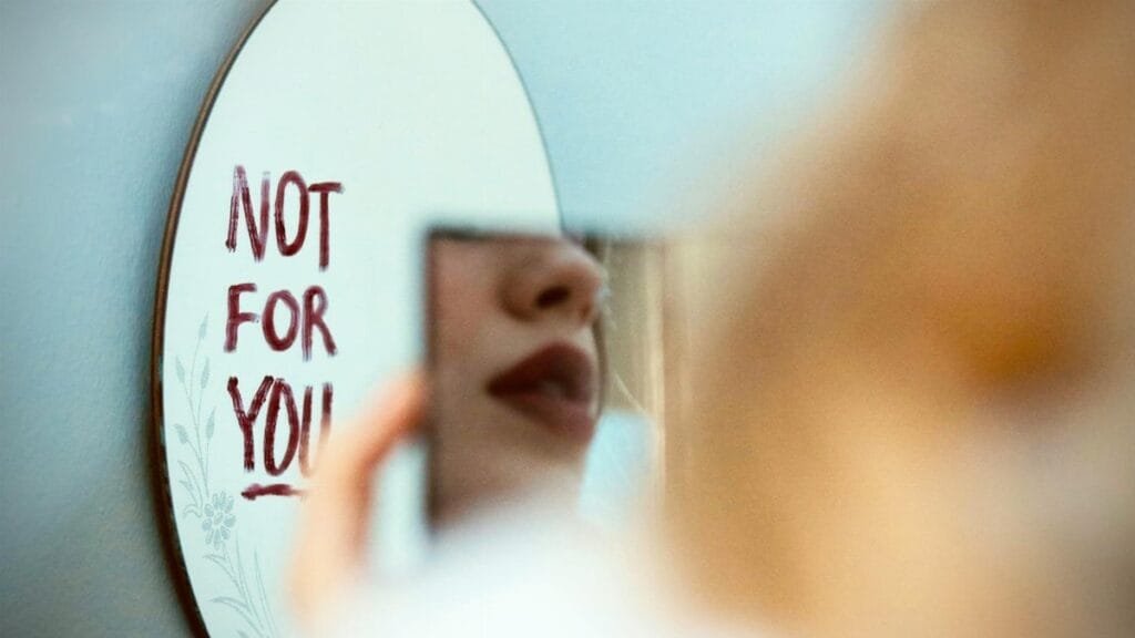 Artistic photo featuring a mirror reflection with 'Not for You' message, evoking mood and introspection.