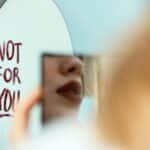 Artistic photo featuring a mirror reflection with 'Not for You' message, evoking mood and introspection.
