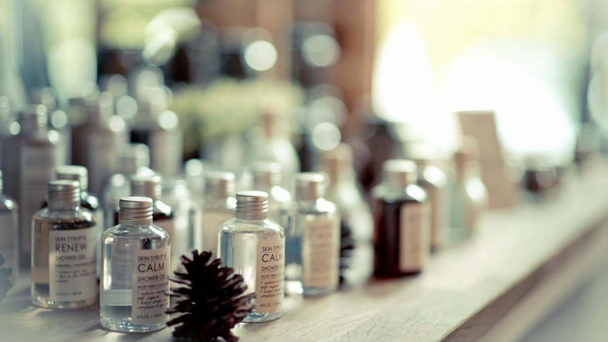 Aesthetic close-up of assorted shower gel bottles arranged on a wooden surface.