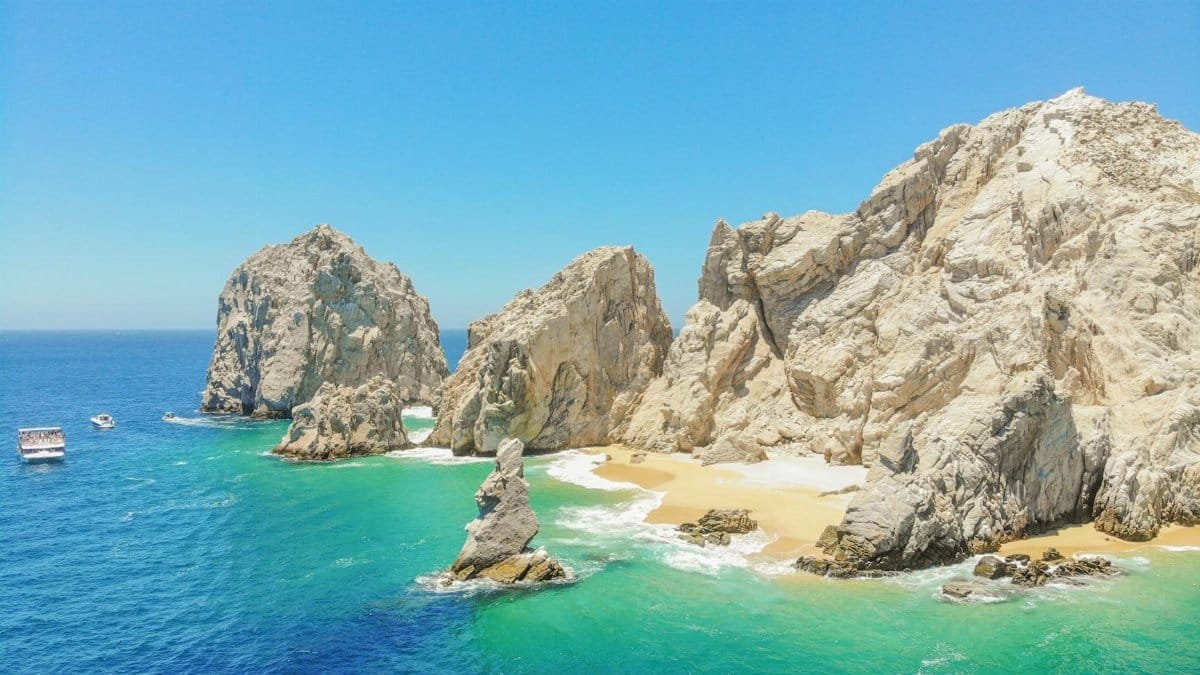 A breathtaking aerial view of El Arco in Cabo San Lucas with turquoise waters and rocky formations.
