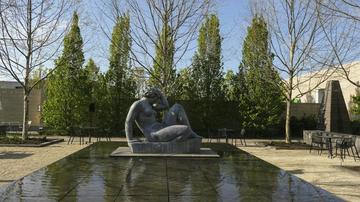 Peaceful garden with a sculptural statue in Columbus, Ohio, showcasing serene landscape design.