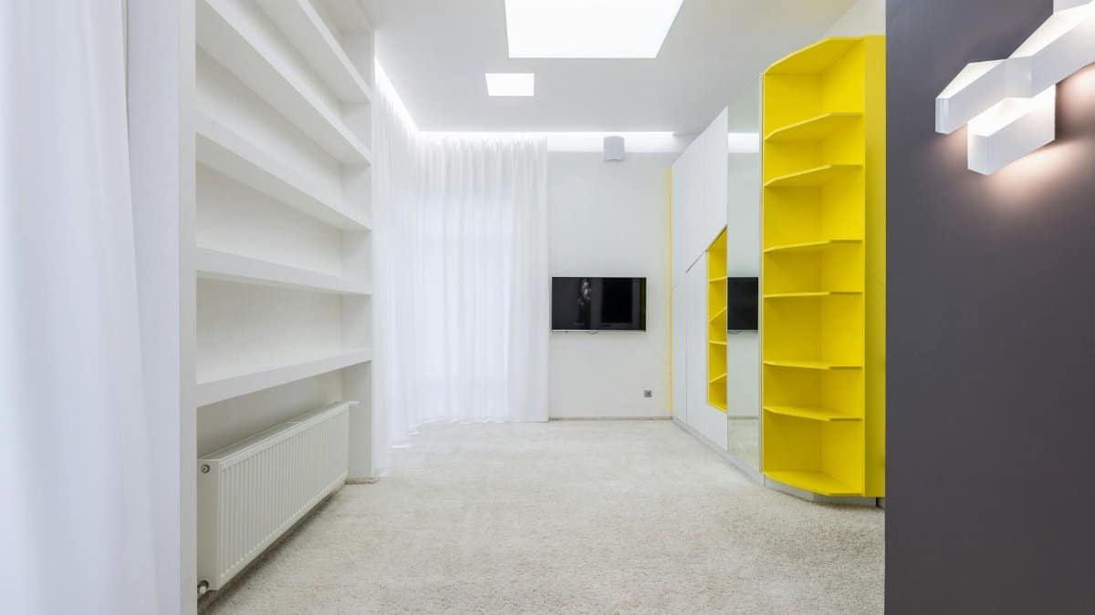 Interior of spacious empty room with new furniture and light walls in modern apartment