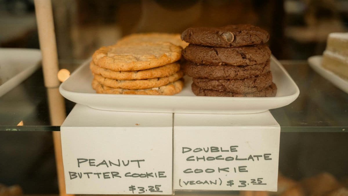 Display of peanut butter and vegan chocolate cookies in a bakery shop.