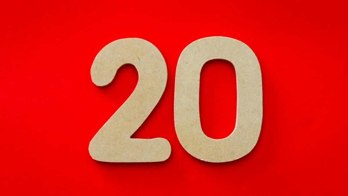 Wooden number 20 on vibrant red background, perfect for design themes.