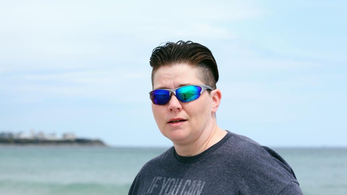 Person in sunglasses with short hair at a beach in Hampton, New Hampshire.