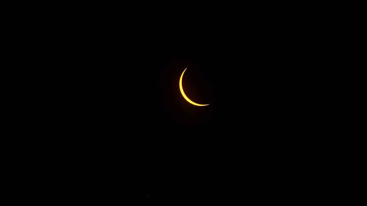A vivid crescent moon against a dark night sky, captured in St. Louis, Missouri.