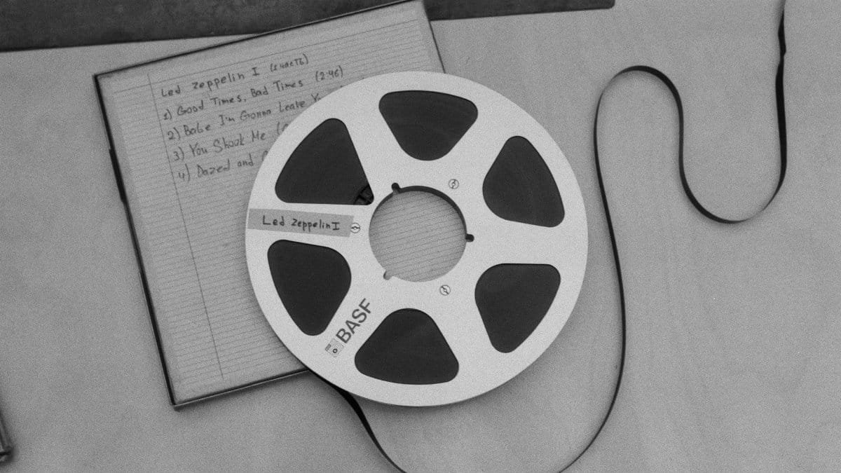 A black and white photo of a vintage BASF reel-to-reel tape with Led Zeppelin tracklist.