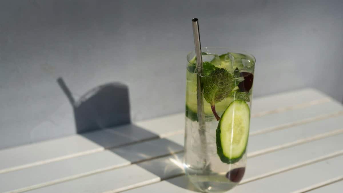 Chilled cucumber mint cocktail with a straw, perfect for a refreshing summer day.
