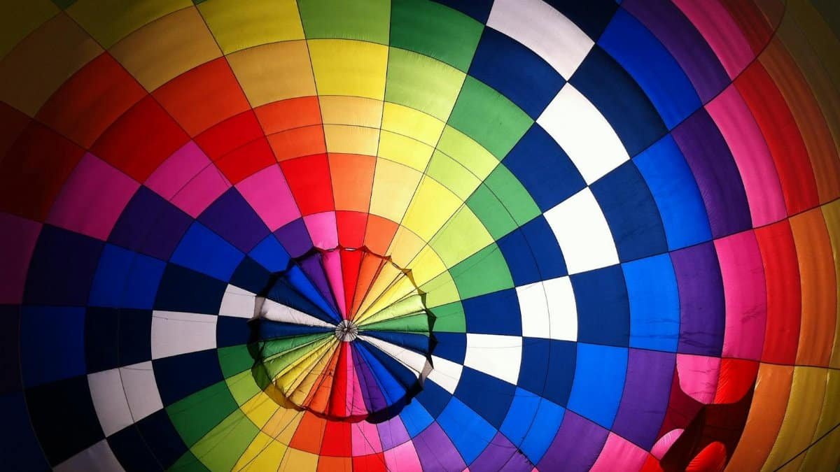 Vibrant interior shot of a colorful hot air balloon, showcasing its rainbow pattern and design.