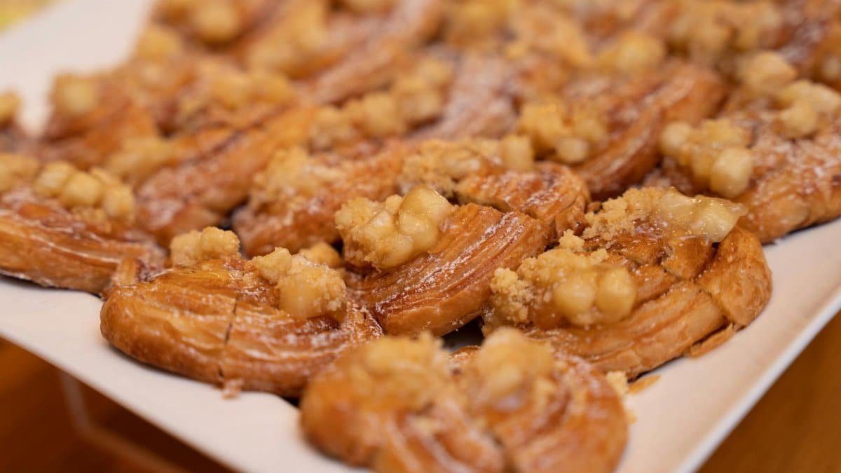 Close-up of freshly baked apple pastries topped with cinnamon, perfect for dessert.
