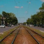 Urban railway tracks in Bratislava on a bright summer day with clear blue skies.