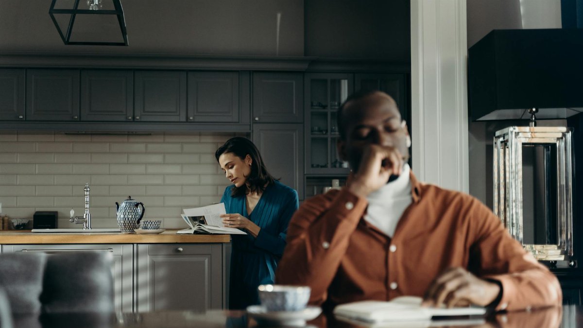 Elegant indoor scene of a couple enjoying a morning, reading and drinking coffee.