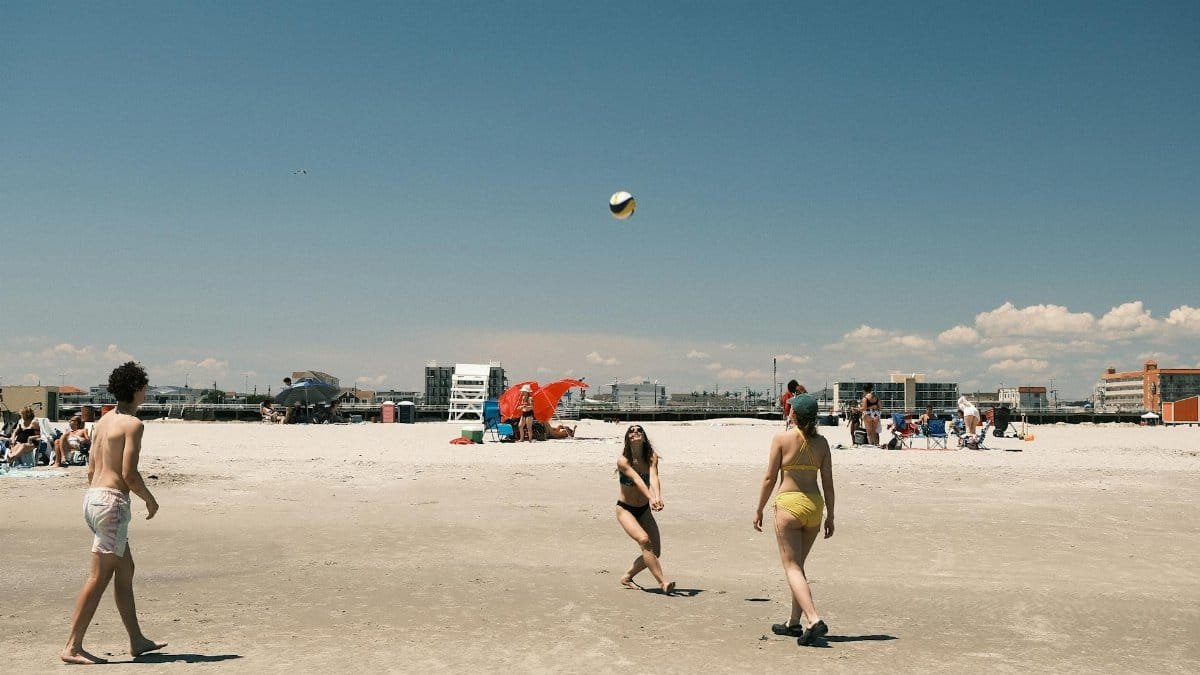 A lively beach volleyball game under a clear sky at Cape May, New Jersey.