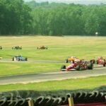 A thrilling outdoor car race featuring colorful formula cars speeding around a track.