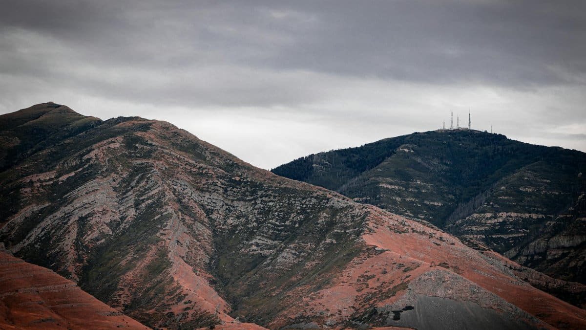 Stunning image of mountains with a dramatic cloudy sky. Perfect for nature and travel-themed projects.