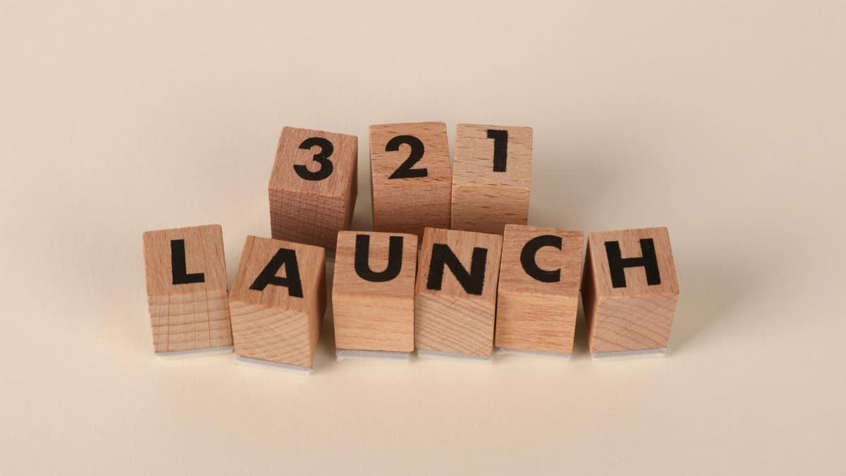 Wooden blocks arranged to spell '3, 2, 1 Launch' symbolizing a countdown.