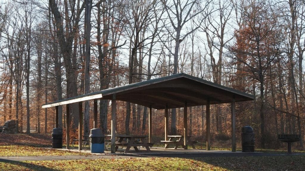 Scenic view of a wooden picnic pavilion surrounded by autumn trees in Warrington, Pennsylvania.