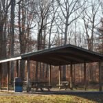 Scenic view of a wooden picnic pavilion surrounded by autumn trees in Warrington, Pennsylvania.