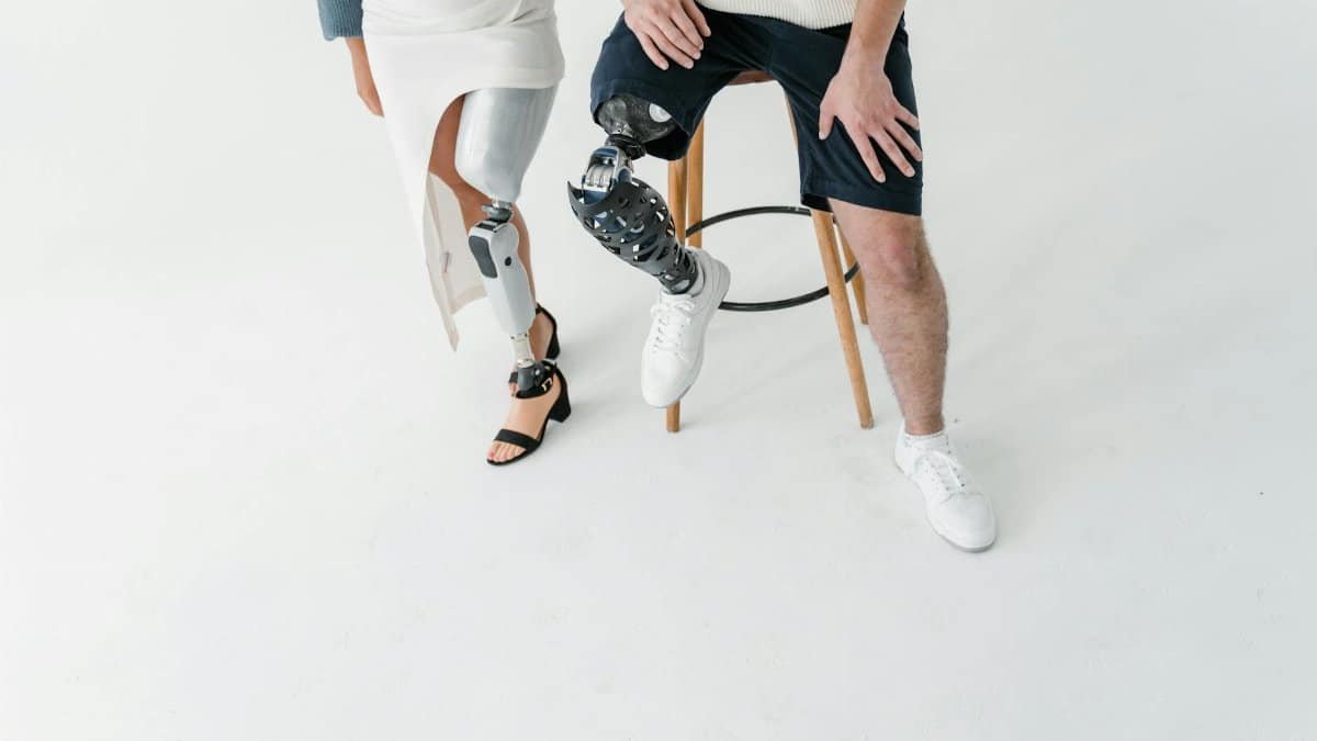 Studio shot showcasing a man and woman with prosthetic legs, symbolizing empowerment and inclusion.