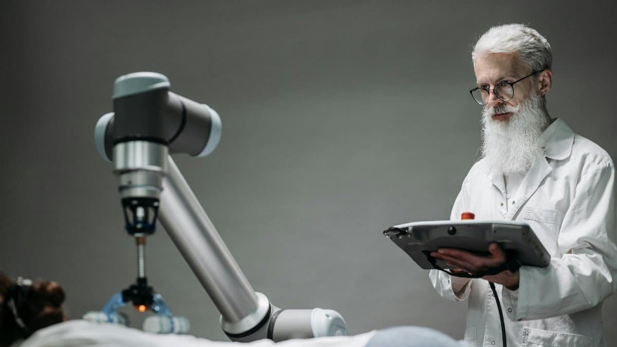 Senior scientist observing robot performing a task indoors.