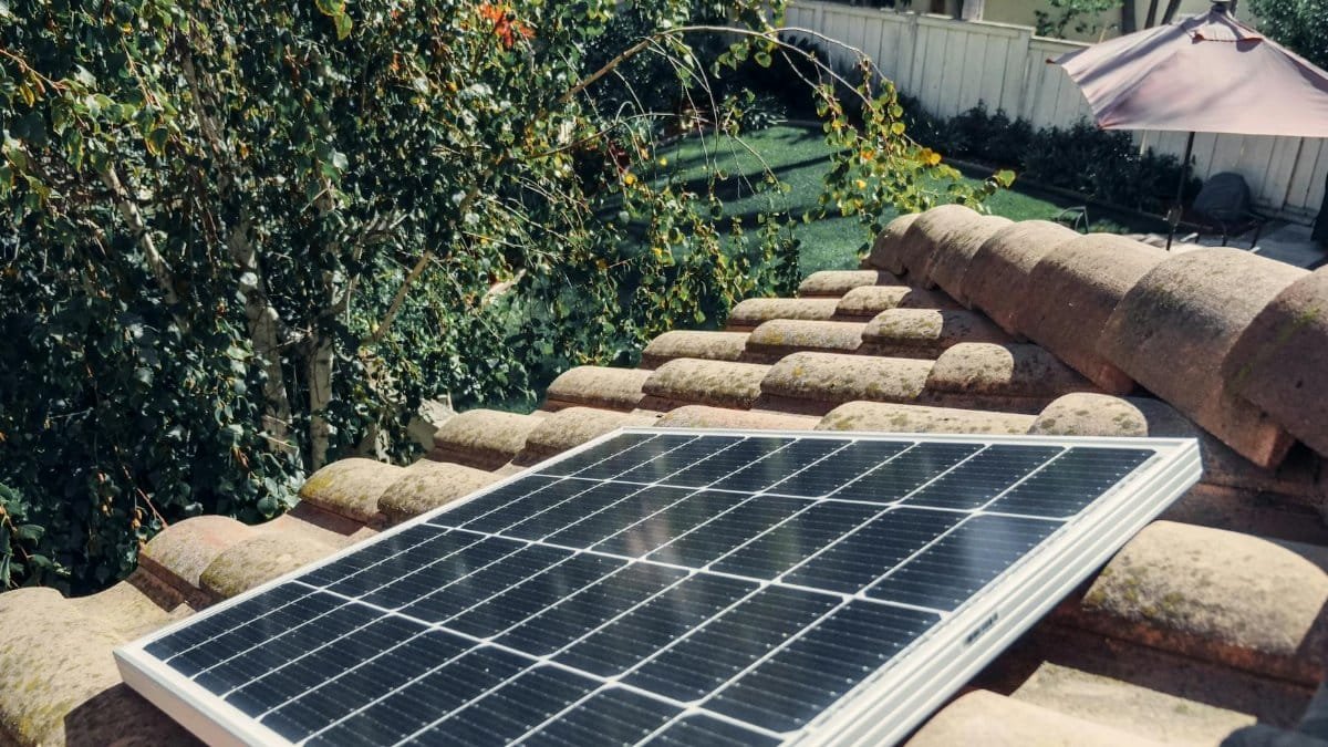 Close-up of a solar panel installed on a tiled roof, capturing clean energy.