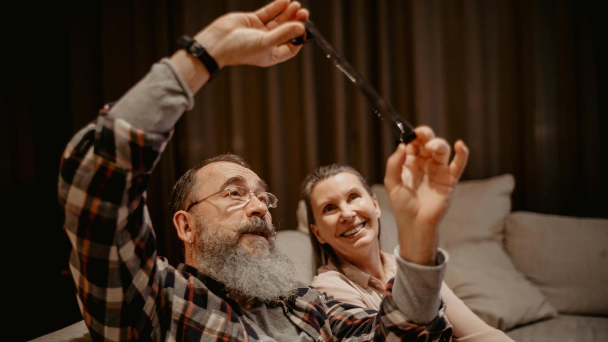 Happy senior couple laughing and enjoying their time together indoors.