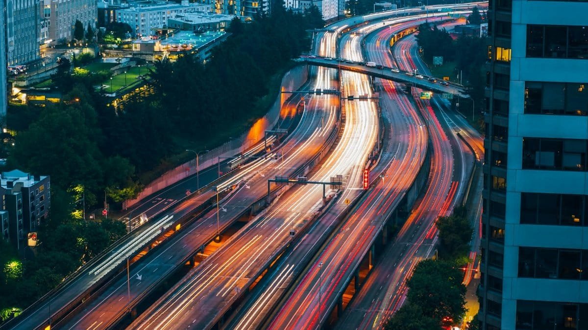 Dynamic night-time cityscape of Seattle with vibrant traffic trails, highlighting the bustling urban life.