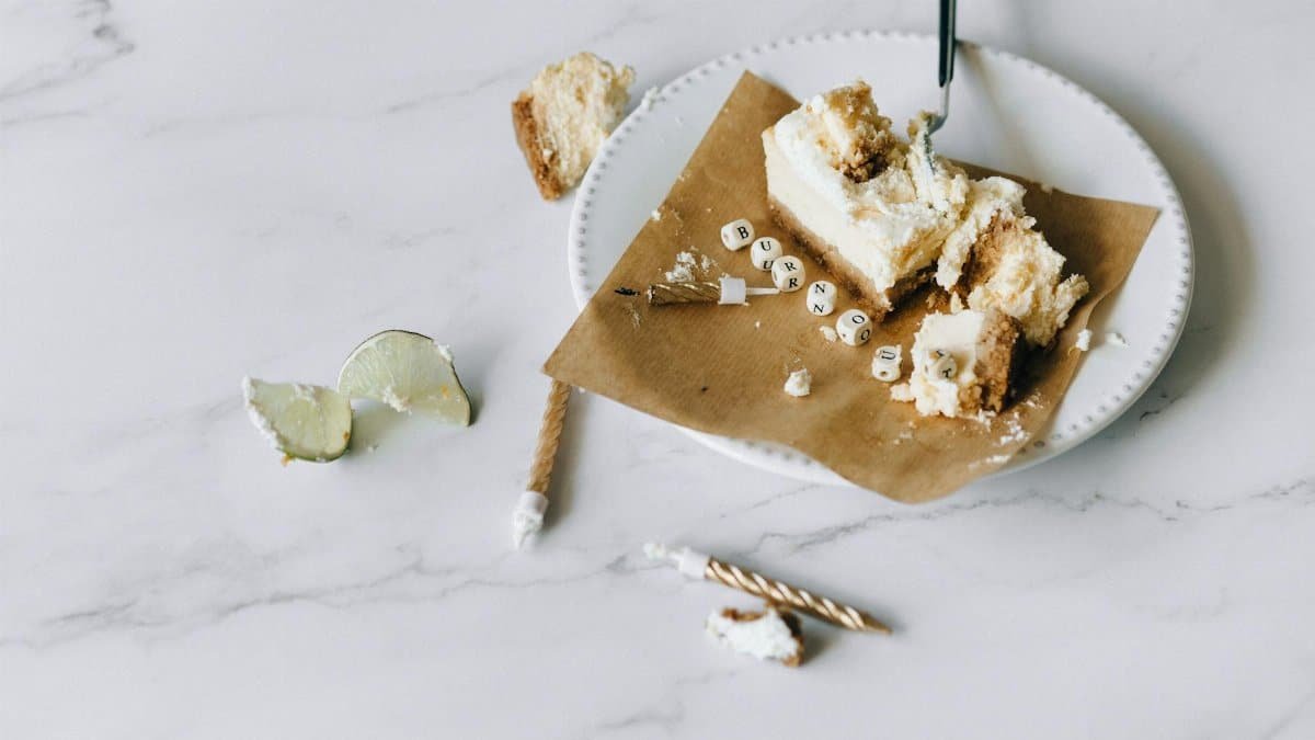 A half-eaten cake with the word 'burnout' on a plate, symbolizing stress and fatigue.